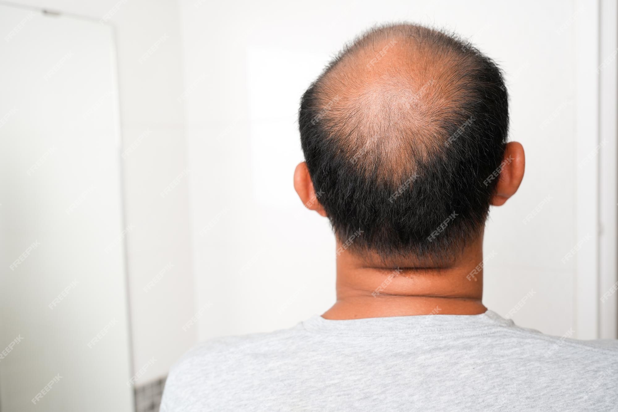 Premium Photo | Back view of bald asian male standing in bathroom