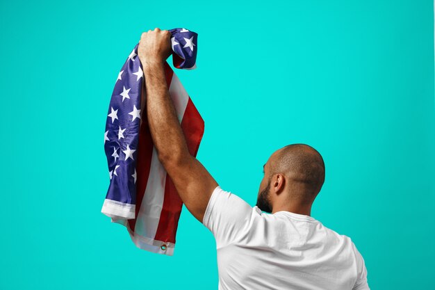 Back view of a black man holding USA flag