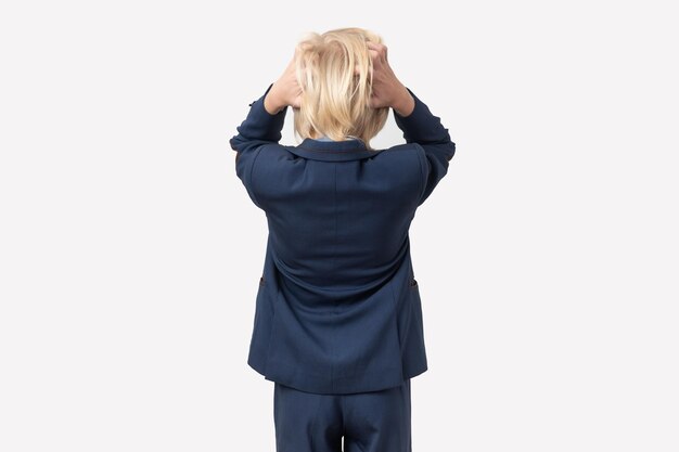 Back view of blonde businessman in suit suffering from headache against white background