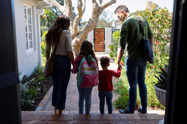 Back view of caucasian family heading to school and work