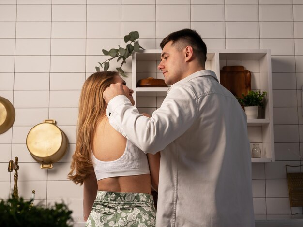 Back view of couple cooking and lovingly looking at each other romantic atmosphere in relationship c