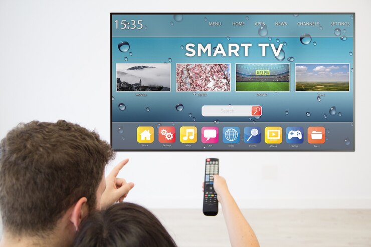 Back view couple watching smart tv on television at home.