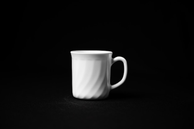 Back view of empty coffee cup isolated on black surface