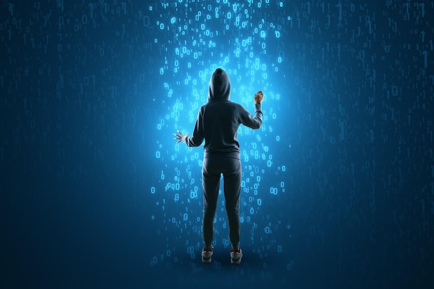 back view of hacker using abstract glowing binary code hologram on blue background programming hacking and theft concept