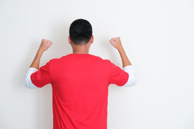 Back view on indonesian man clenched fist during independence day celebration