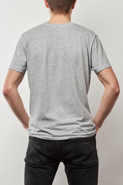 Back view of man in cotton tshirt with copy space isolated on grey