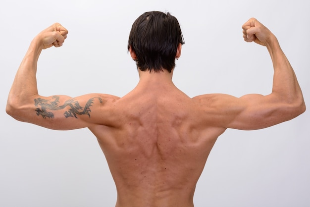 Back view of muscular man flexing both arms