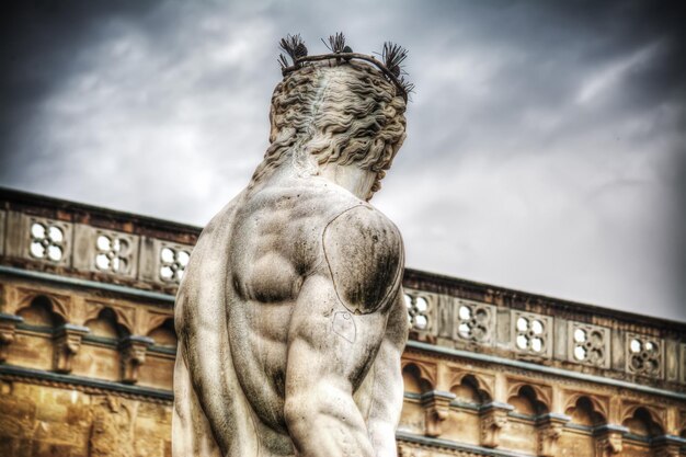 Back view of Neptune statue in Piazza della Signoria in Florence Italy