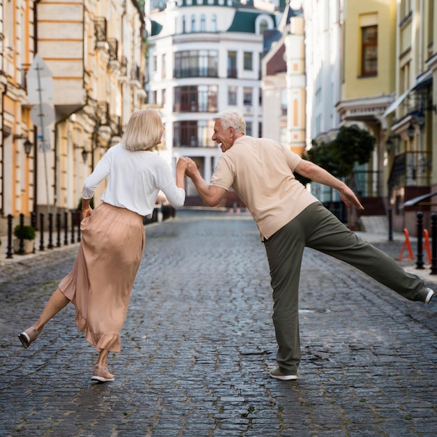 Back view of older happy couple in the city