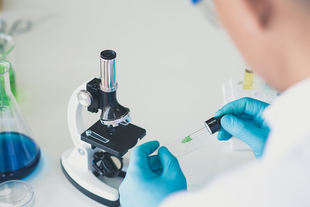 Back view of researcher or scientist working in laboratory