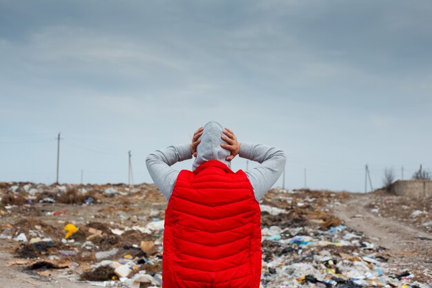 Back view of scared human with hands on head in red jacket