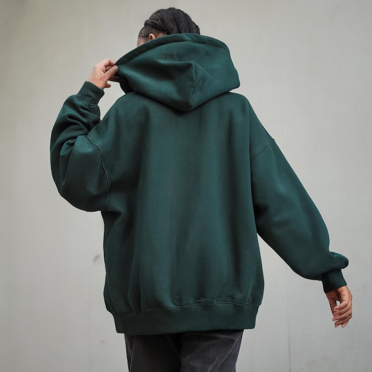 Photo back view of trendy dark green oversized hoodie