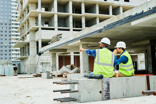 Back View Two Workers on Site