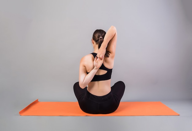 Back view of woman doing hand warm-up