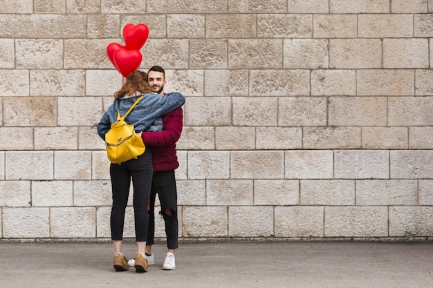 Back view woman hugging boyfriend