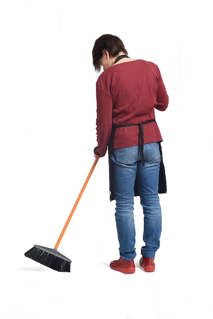 Back view of a woman sweeping on white background