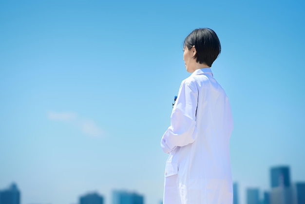 Back view of a woman in a white coat