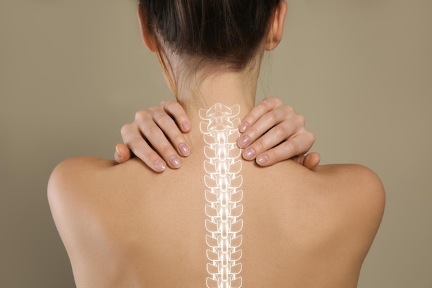 Back view of woman with perfect smooth skin on beige background closeup Beauty and body care