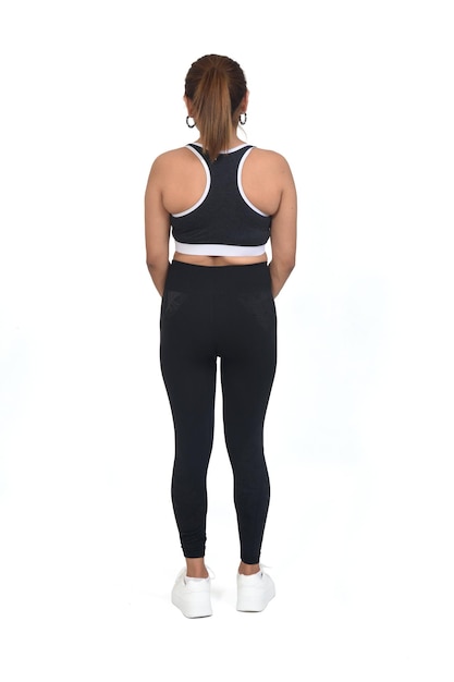 Back view of a woman with sportswear and sneaker white background