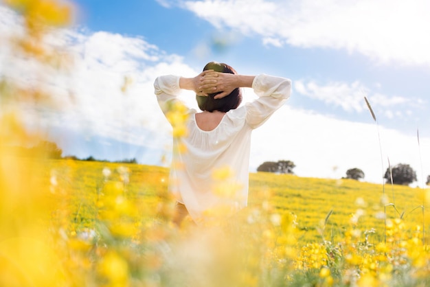 Back view of a woman in yellow field