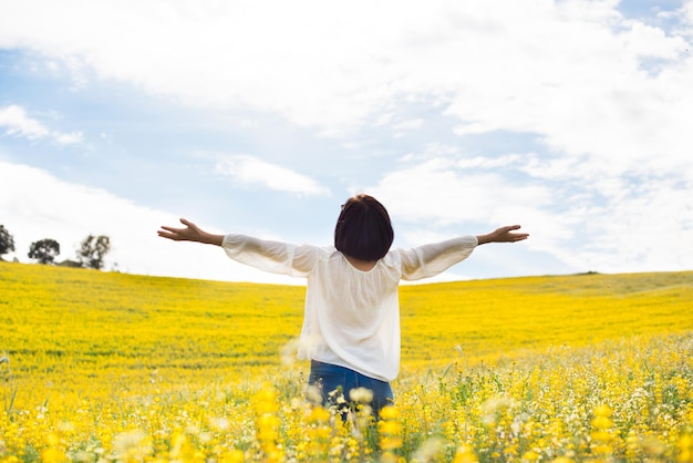 Back view of a woman in yellow field