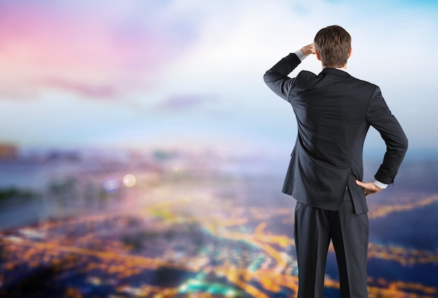 Back view of young business man on  background