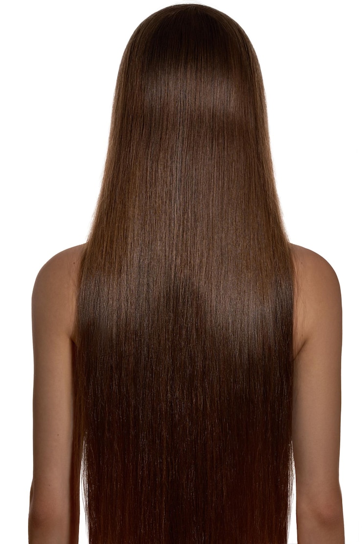 Photo back view of a young female with long brown hair isolated on white