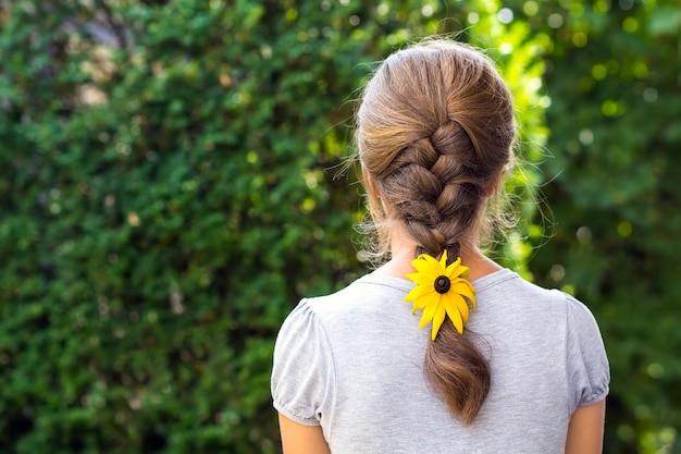 Back of a woman with flower in her hair