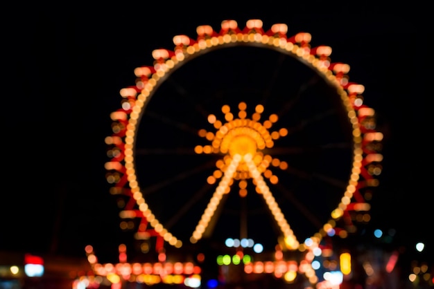 Backdrop defocused illuminated Ferris wheel night view