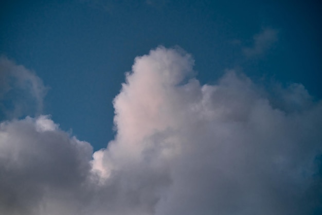 Backdrop of a white cloud in a blue summer sky Natural background with soft clouds