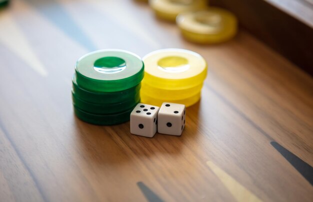 Backgammon dice and chips closeup on game board