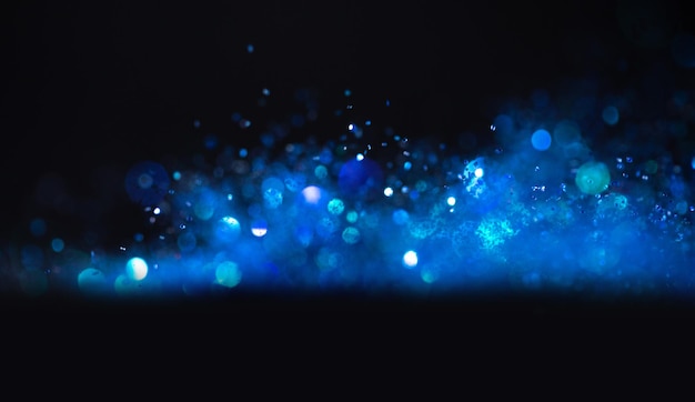 Photo background of abstract blue and black glitter lights. defocused