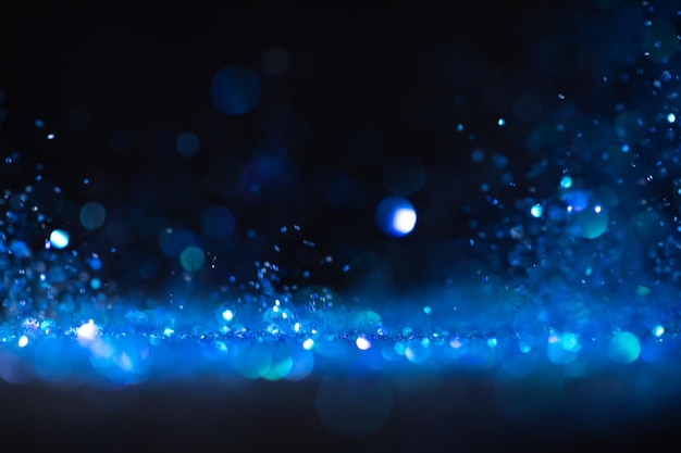 Background of abstract blue and black glitter lights. defocused