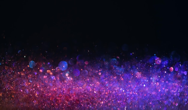 Photo background of abstract glitter lights. purple and blue. de focused