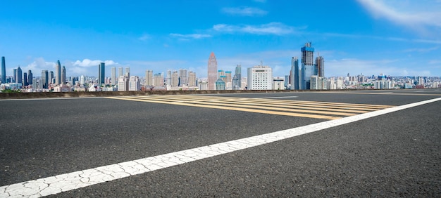 Background of asphalt pavement and urban architectural landscape skyline