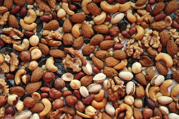 background of assorted different nuts on a white