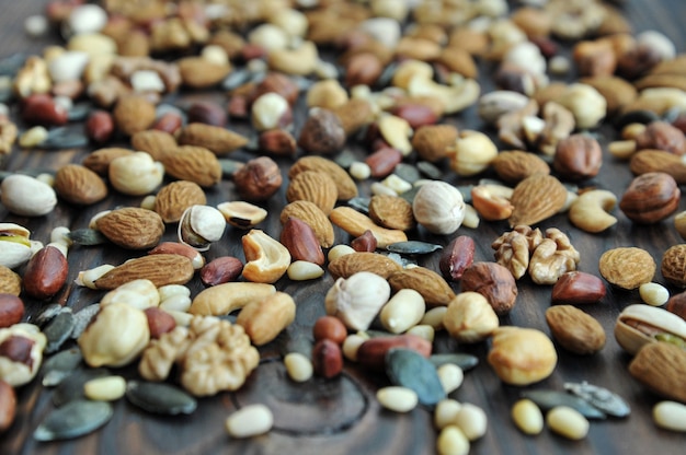 background of assorted different nuts on wooden surface