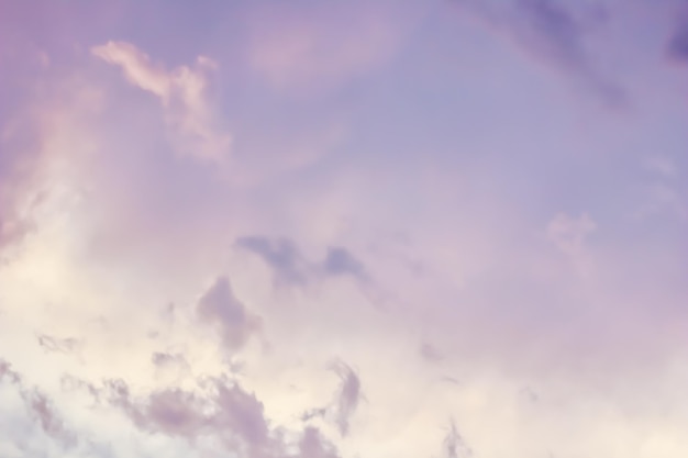 Background of a beautiful pink and pale purple sky with clouds at sunset. High quality photo