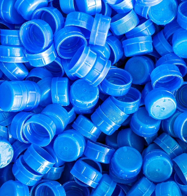 Background of blue plastic water bottle cap lots of piles togetherclosup