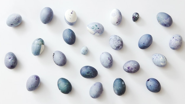 Background of blue and white eggs on a white background