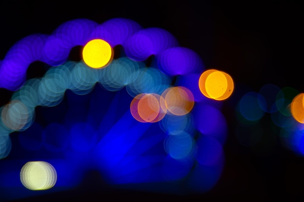 Background blurred abstraction of colored lanterns and decorations bokeh texture of street colored lights
