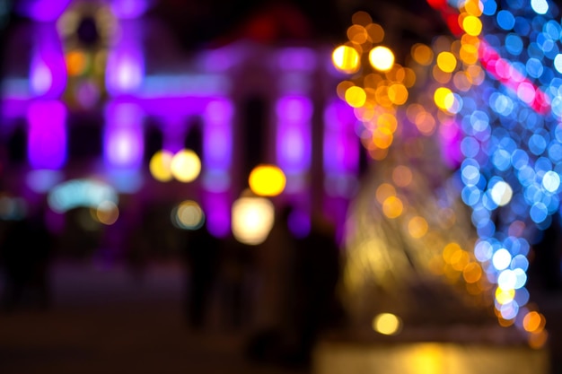 Background blurred abstraction of colored lanterns and decorations bokeh texture of street colored lights