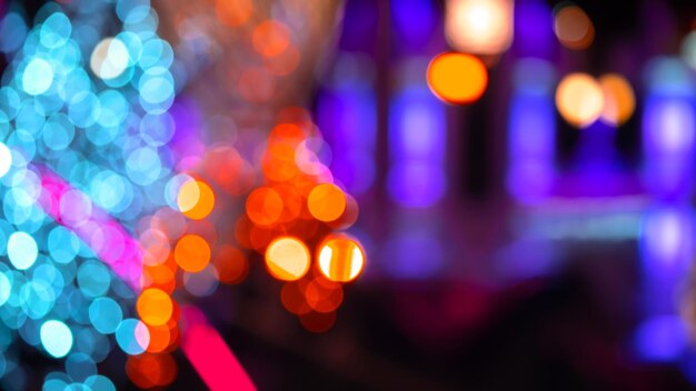 Background blurred abstraction of colored lanterns and decorations bokeh texture of street colored lights