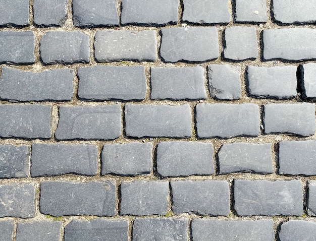 The background of the brick paving slabs is gray Sidewalk tiles closeup