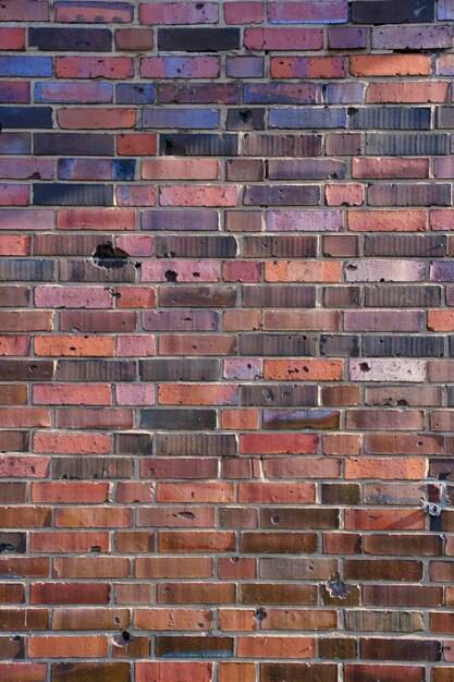 Background brick wall made old German red burnt brick with traces bullets and shrapnel after World War II