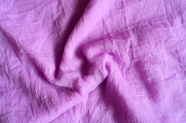 Background of bright pink cotton wrinkled fabric cloth