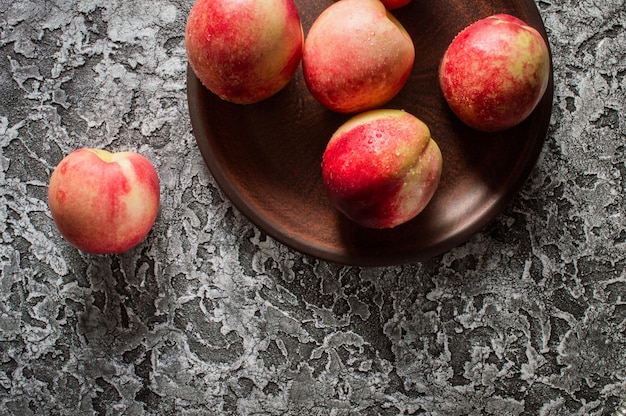 Background of bright and ripe nectarines in full screen Autumn wallpaper of exotic southern fruits The concept of harvesting