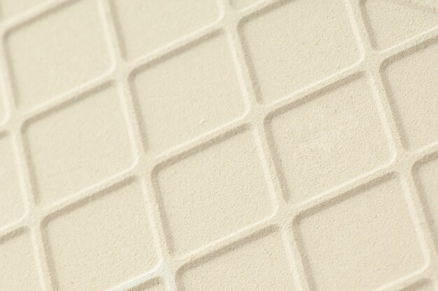 Background of ceramic tiles with square veins of cream color. ridge background