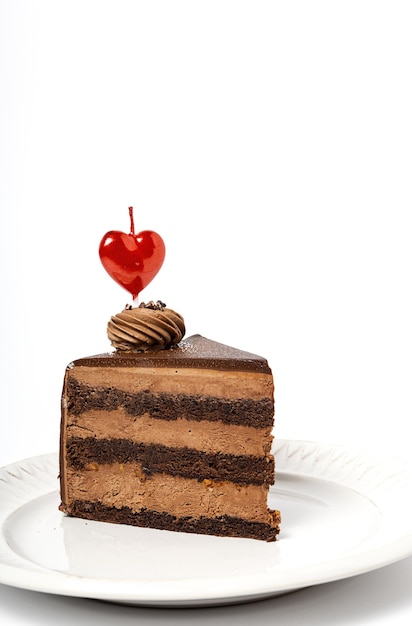 Background of chocolate cake with heart candle for Valentine's Day