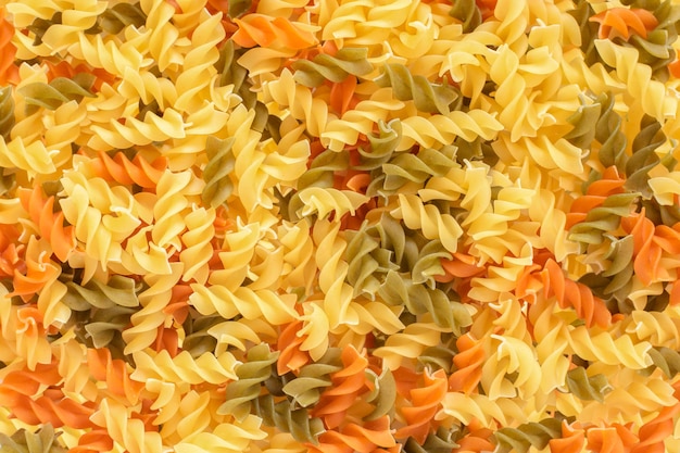 Photo background of colored spinach and tomato pasta